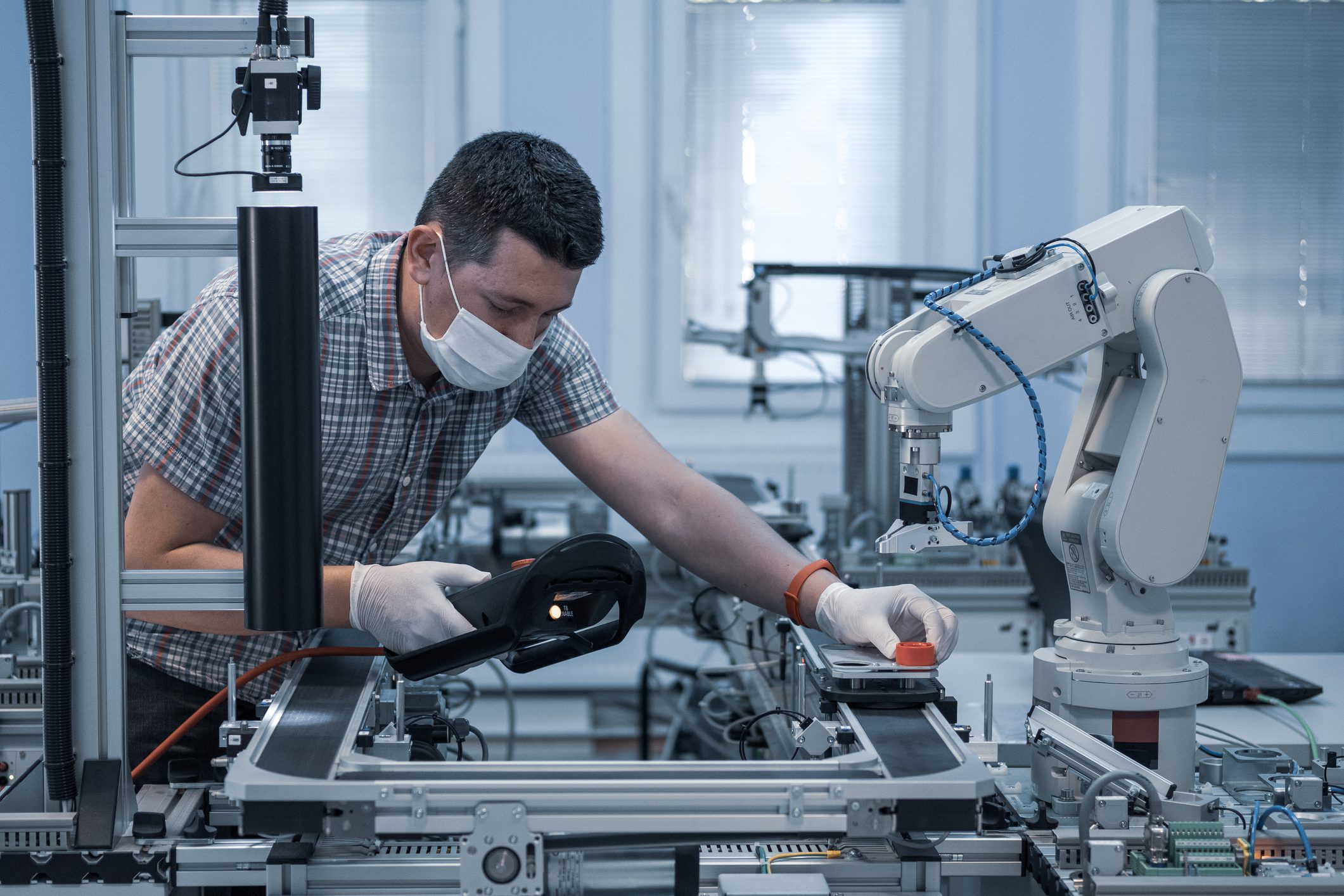 industry 4.0 : Man with surgical mask and gloves against COVID-19